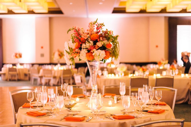 It’s a great idea to incorporate a mix of high and low centerpieces; it helps break up the room and adds sophistication. Photo Credit: Krista A. Jones Photography 